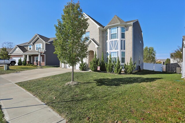 1664 Woodside Cir, Franklin, IN 46131 - view of front of home featuring concrete driveway, brick siding, and a gate