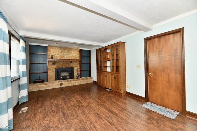 18906 Crestview Ct, Westfield, IN 46074 - unfurnished living room with beamed ceiling, wood finished floors, a fireplace, a textured ceiling, and baseboards