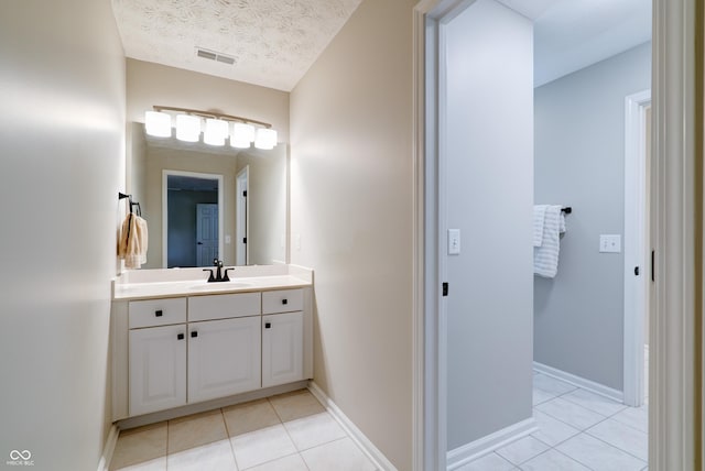 9154 Sargent Manor Ct, Indianapolis, IN 46256 - bathroom with tile patterned flooring, vanity, a textured ceiling, and baseboards