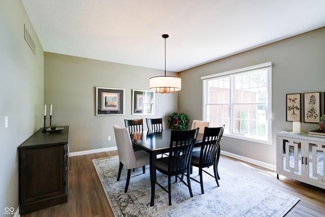 9154 Sargent Manor Ct, Indianapolis, IN 46256 - dining space featuring dark wood-style flooring, a chandelier, and baseboards