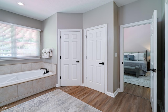9154 Sargent Manor Ct, Indianapolis, IN 46256 - bathroom with ensuite bath, a garden tub, wood finished floors, recessed lighting, and baseboards