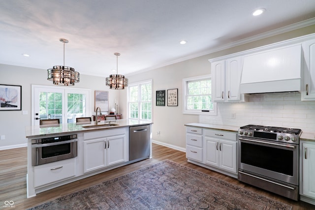 9154 Sargent Manor Ct, Indianapolis, IN 46256 - kitchen with stainless steel appliances, premium range hood, a sink, a chandelier, and white cabinets