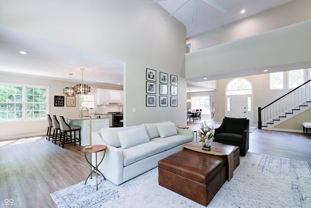 9154 Sargent Manor Ct, Indianapolis, IN 46256 - living room with light wood-style flooring, stairway, recessed lighting, baseboards, and a chandelier