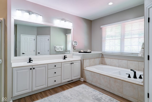 9154 Sargent Manor Ct, Indianapolis, IN 46256 - full bath featuring double vanity, a bath, wood finished floors, and recessed lighting