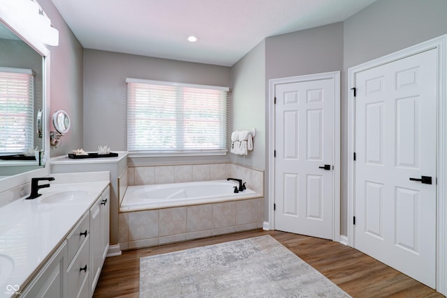 9154 Sargent Manor Ct, Indianapolis, IN 46256 - full bathroom with double vanity, a bath, and wood finished floors