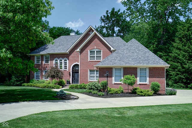 9154 Sargent Manor Ct, Indianapolis, IN 46256 - colonial home with roof with shingles, a front lawn, a chimney, and brick siding