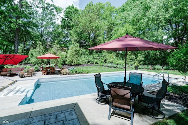 9154 Sargent Manor Ct, Indianapolis, IN 46256 - swimming pool with outdoor dining area, a patio, and view of scattered trees