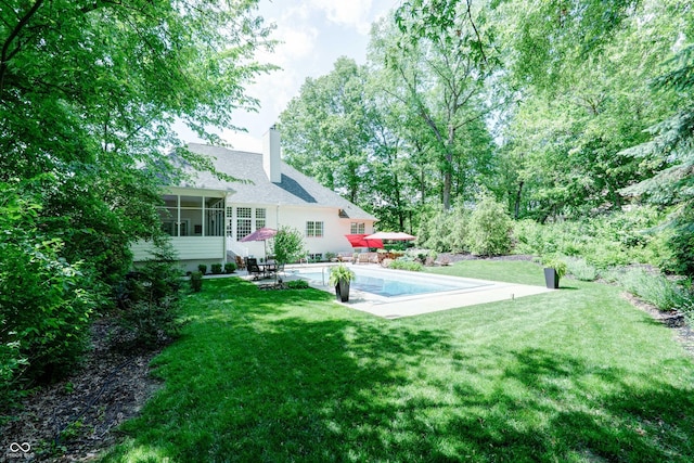 9154 Sargent Manor Ct, Indianapolis, IN 46256 - view of green lawn featuring a patio, a sunroom, and an outdoor pool