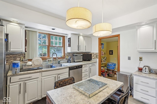 6210 Mckinley Ct, Indianapolis, IN 46220 - kitchen featuring dishwasher, a sink, white cabinetry, tasteful backsplash, and hanging light fixtures