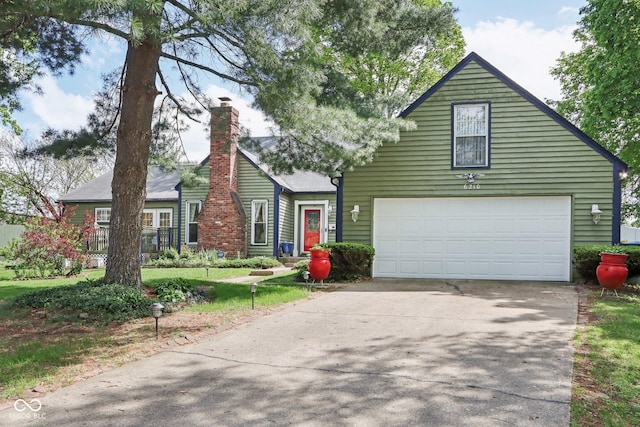 6210 Mckinley Ct, Indianapolis, IN 46220 - view of front of house with a garage, concrete driveway, and a chimney