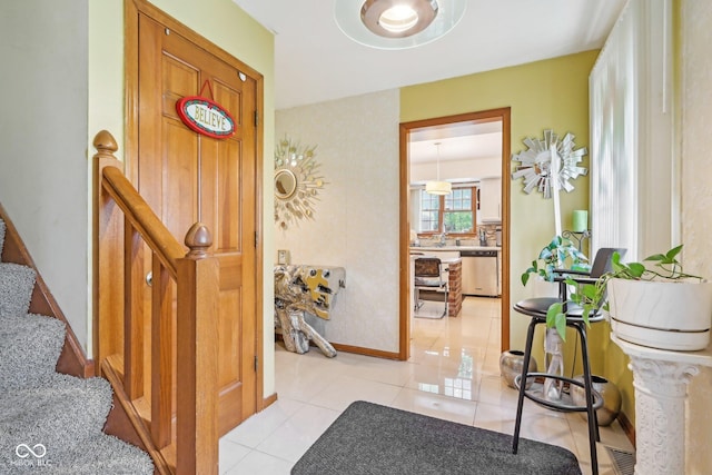 6210 Mckinley Ct, Indianapolis, IN 46220 - entrance foyer with light tile patterned floors, baseboards, and stairway