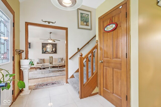 6210 Mckinley Ct, Indianapolis, IN 46220 - entryway with stairway, ceiling fan, and light tile patterned flooring
