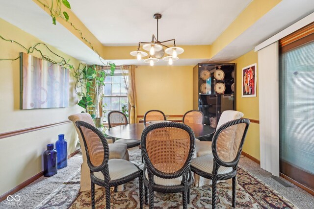 6210 Mckinley Ct, Indianapolis, IN 46220 - carpeted dining space featuring baseboards and a chandelier