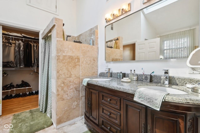 6210 Mckinley Ct, Indianapolis, IN 46220 - full bathroom with double vanity, a walk in closet, walk in shower, and wood finished floors
