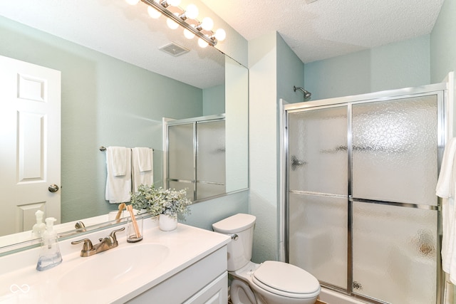 15411 Wandering Way, Noblesville, IN 46060 - bathroom featuring vanity, a stall shower, toilet, and a textured ceiling