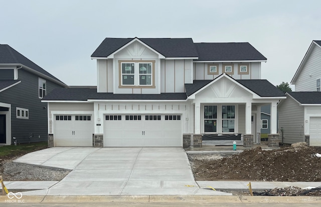 7145 Firestone Rd, Whitestown, IN 46075 - view of front of house featuring covered porch, concrete driveway, stone siding, and a garage