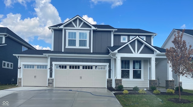 7145 Firestone Rd, Whitestown, IN 46075 - craftsman-style house featuring board and batten siding, stone siding, driveway, a garage, and a porch