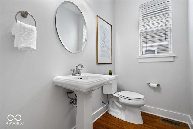 2448 Broadway St, Indianapolis, IN 46205 - half bath with baseboards, wood finished floors, and toilet