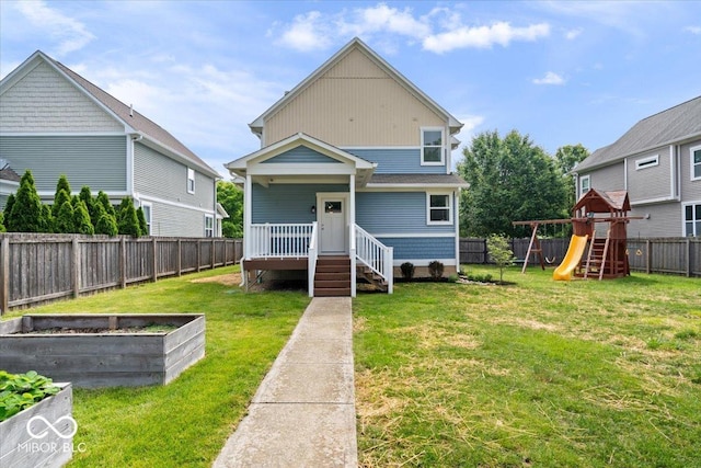 2448 Broadway St, Indianapolis, IN 46205 - back of house featuring a playground and a vegetable garden