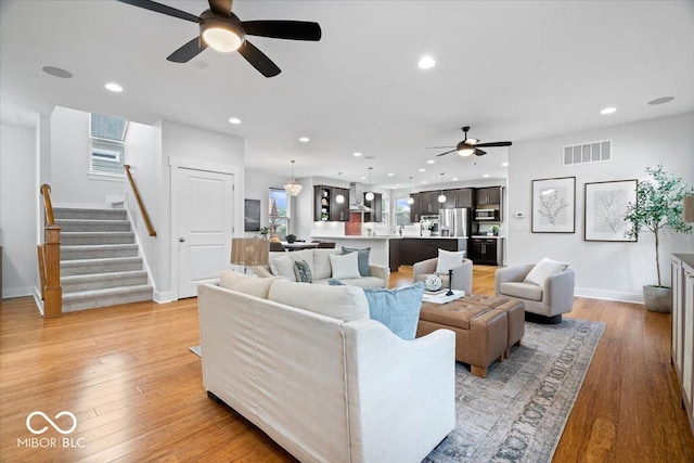 2448 Broadway St, Indianapolis, IN 46205 - living room with a ceiling fan, light wood finished floors, stairway, recessed lighting, and baseboards