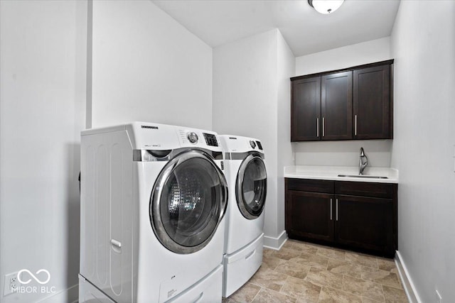 2448 Broadway St, Indianapolis, IN 46205 - laundry room with independent washer and dryer, cabinet space, baseboards, and stone finish floors