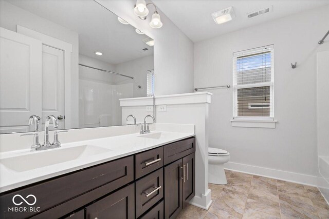 2448 Broadway St, Indianapolis, IN 46205 - bathroom featuring toilet, double vanity, baseboards, and bathing tub / shower combination