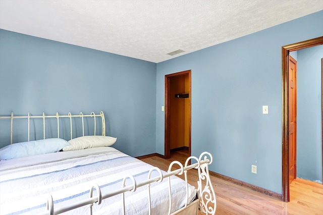 50 Charing Cross Rd, Indianapolis, IN 46217 - bedroom with wood finished floors, baseboards, and a textured ceiling