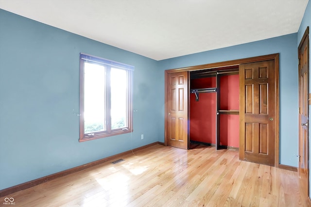 50 Charing Cross Rd, Indianapolis, IN 46217 - unfurnished bedroom featuring light wood-type flooring, baseboards, and a closet