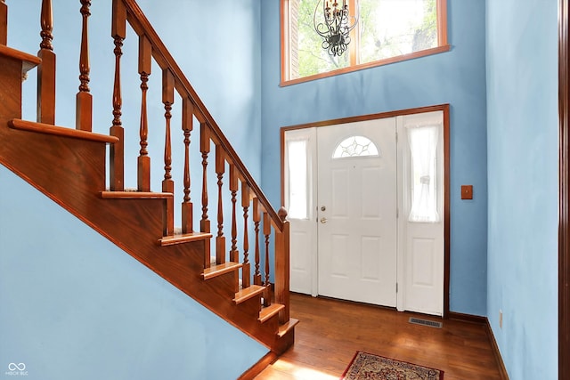 50 Charing Cross Rd, Indianapolis, IN 46217 - foyer entrance featuring a high ceiling, stairs, wood finished floors, healthy amount of natural light, and a chandelier