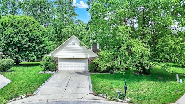 50 Charing Cross Rd, Indianapolis, IN 46217 - view of front of home with brick siding, a front yard, and concrete driveway