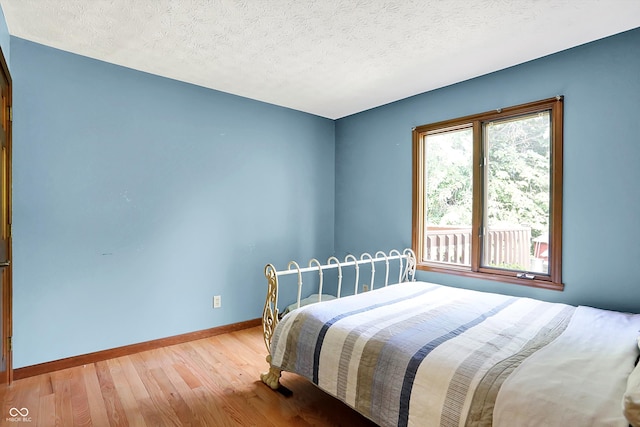 50 Charing Cross Rd, Indianapolis, IN 46217 - bedroom featuring wood finished floors, baseboards, and a textured ceiling
