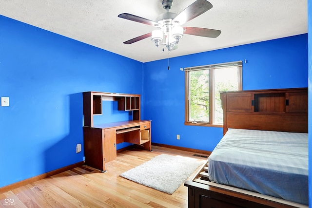 50 Charing Cross Rd, Indianapolis, IN 46217 - bedroom featuring baseboards, wood finished floors, a textured ceiling, and a ceiling fan
