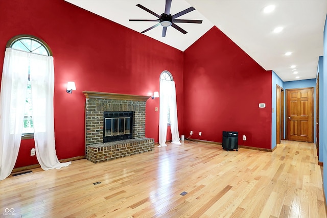 50 Charing Cross Rd, Indianapolis, IN 46217 - unfurnished living room featuring ceiling fan, high vaulted ceiling, wood finished floors, a fireplace, and recessed lighting