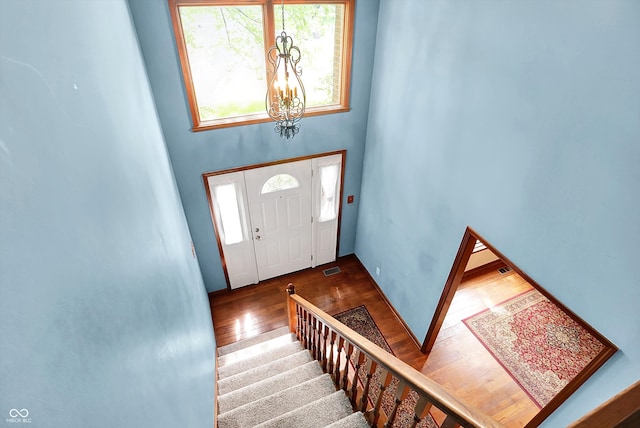50 Charing Cross Rd, Indianapolis, IN 46217 - entryway featuring wood finished floors, a chandelier, plenty of natural light, and stairway