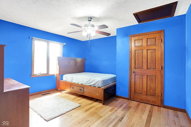 50 Charing Cross Rd, Indianapolis, IN 46217 - bedroom with baseboards, wood finished floors, a textured ceiling, and a ceiling fan