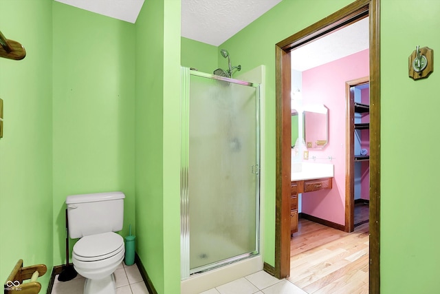 50 Charing Cross Rd, Indianapolis, IN 46217 - full bathroom featuring a stall shower, toilet, vanity, baseboards, and tile patterned floors