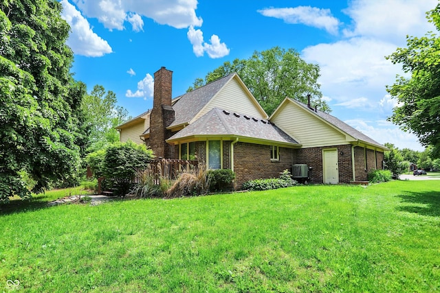 50 Charing Cross Rd, Indianapolis, IN 46217 - view of property exterior featuring a lawn, central AC, brick siding, and a chimney