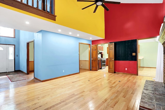 50 Charing Cross Rd, Indianapolis, IN 46217 - unfurnished living room featuring a towering ceiling, ceiling fan, light wood-style floors, baseboards, and recessed lighting