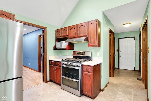 50 Charing Cross Rd, Indianapolis, IN 46217 - kitchen with appliances with stainless steel finishes, under cabinet range hood, light countertops, lofted ceiling, and baseboards