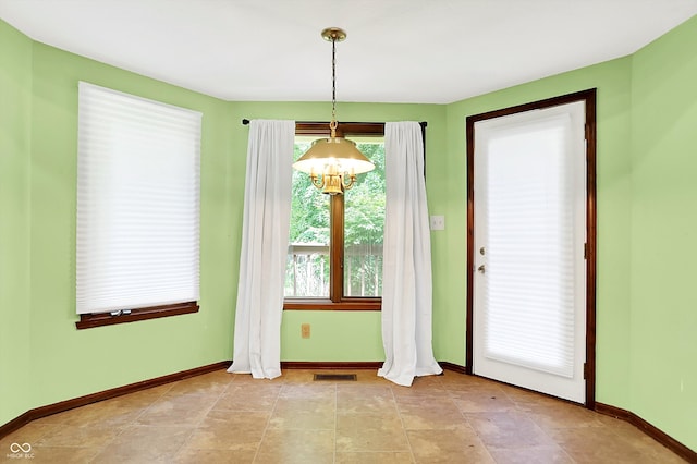 50 Charing Cross Rd, Indianapolis, IN 46217 - unfurnished dining area with a chandelier and baseboards