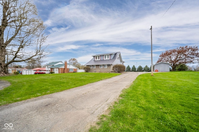 313 S Walnut St, New Castle, IN 47362 - view of front of home featuring metal roof, dirt driveway, a front lawn, and an outbuilding