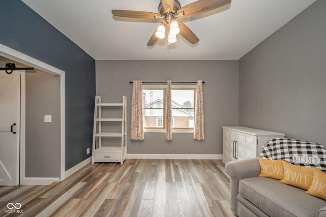 313 S Walnut St, New Castle, IN 47362 - living area with wood finished floors, ceiling fan, and baseboards