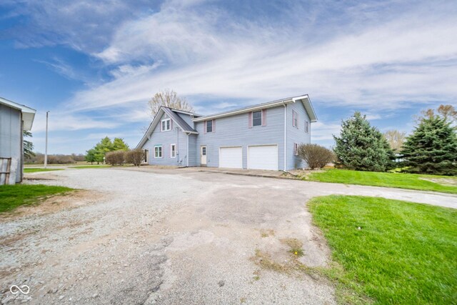 313 S Walnut St, New Castle, IN 47362 - view of home's exterior with an attached garage and asphalt driveway