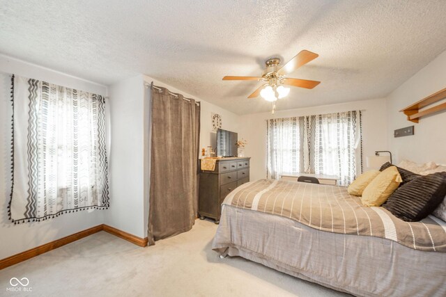 313 S Walnut St, New Castle, IN 47362 - bedroom with light carpet, baseboards, a textured ceiling, and ceiling fan