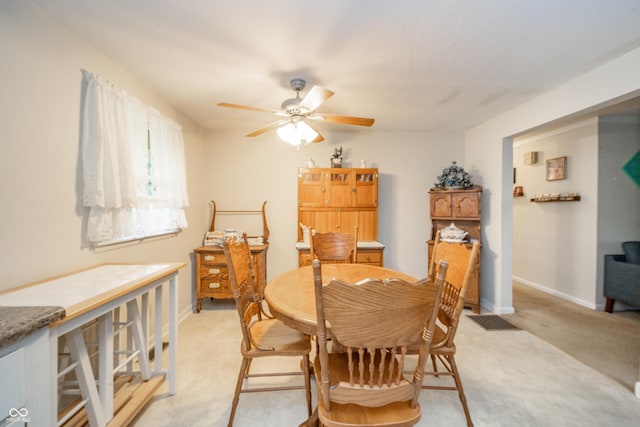 2900 Helms Rd, Anderson, IN 46016 - dining room featuring a ceiling fan, light colored carpet, and baseboards