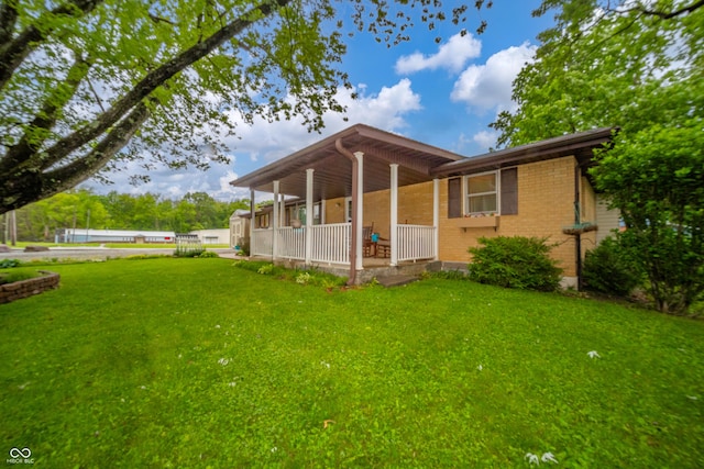 2900 Helms Rd, Anderson, IN 46016 - back of house featuring covered porch, a yard, and brick siding