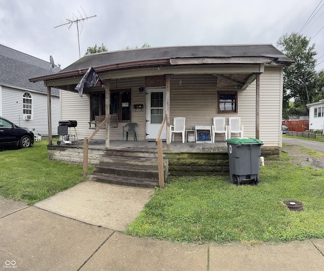 311 W 1st St, Rushville, IN 46173 - view of front of house featuring a porch and a front lawn