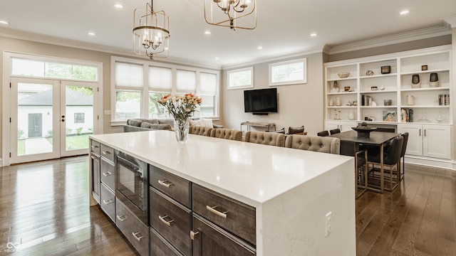 5254 N Park Ave, Indianapolis, IN 46220 - kitchen with built in microwave, ornamental molding, a chandelier, dark wood finished floors, and healthy amount of natural light
