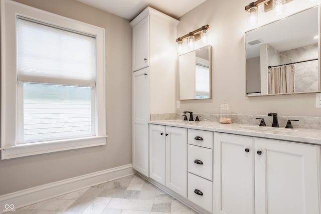 5254 N Park Ave, Indianapolis, IN 46220 - bathroom with marble look tiles, double vanity, baseboards, and curtained shower
