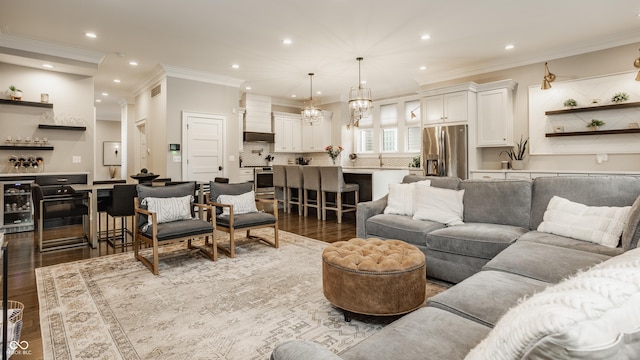 5254 N Park Ave, Indianapolis, IN 46220 - living area featuring wood finished floors, ornamental molding, beverage cooler, recessed lighting, and a chandelier